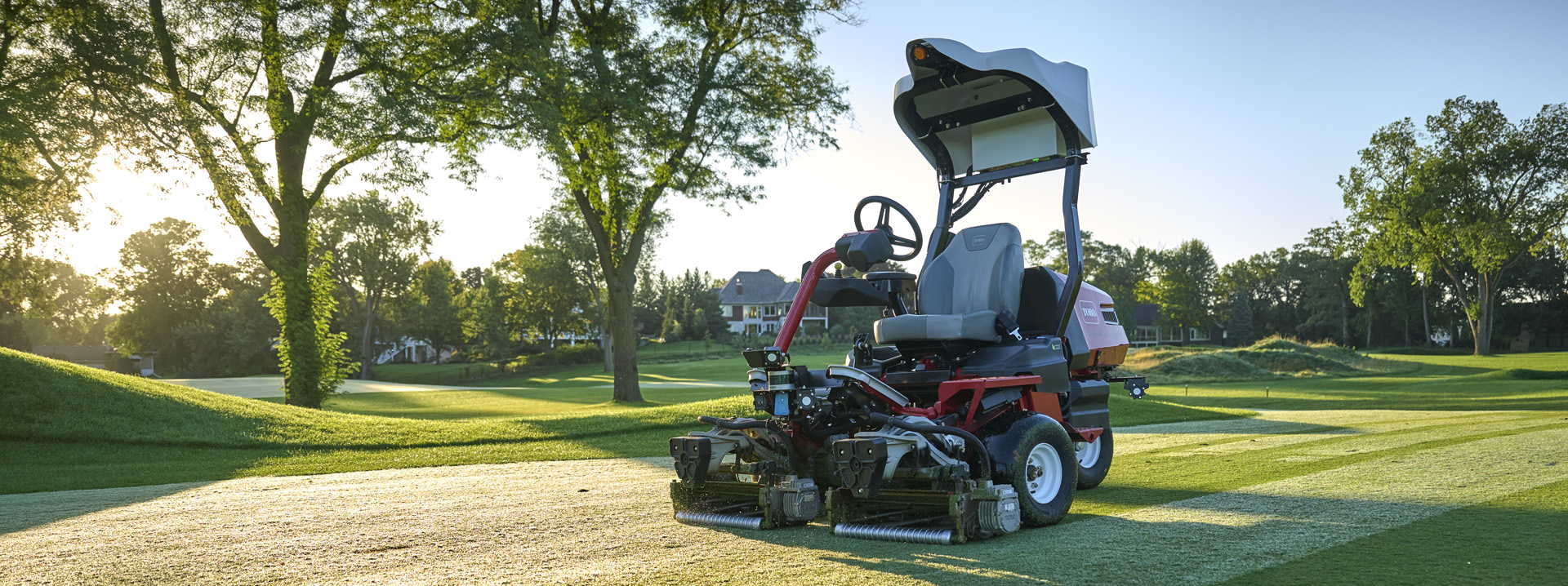 Toro autonomous fairway mower cutting a golf course fairway at sunrise